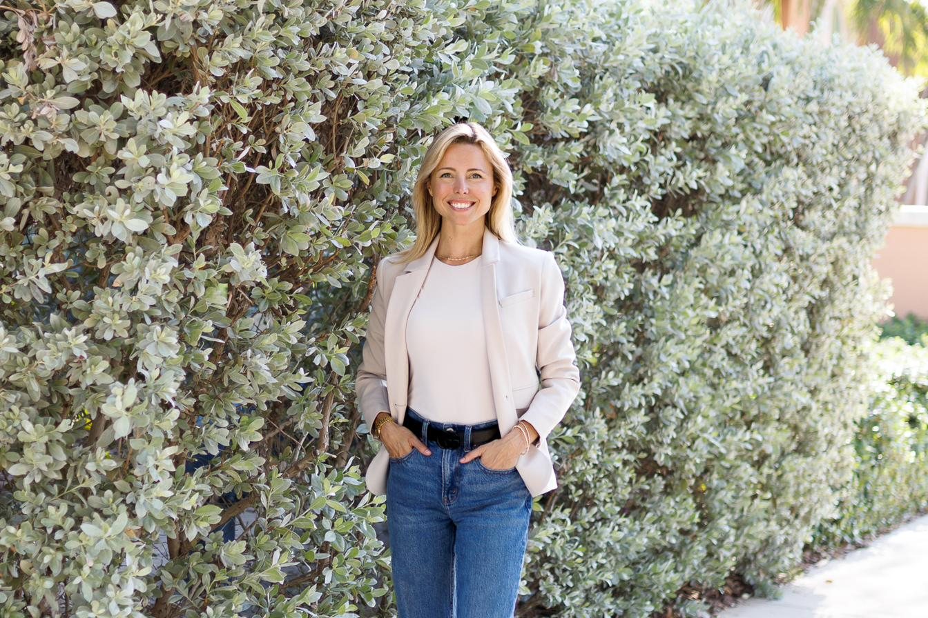 Dr. Ann Munroe, DC, chiropractor in St. Petersburg, FL, smiling outdoors in a blazer